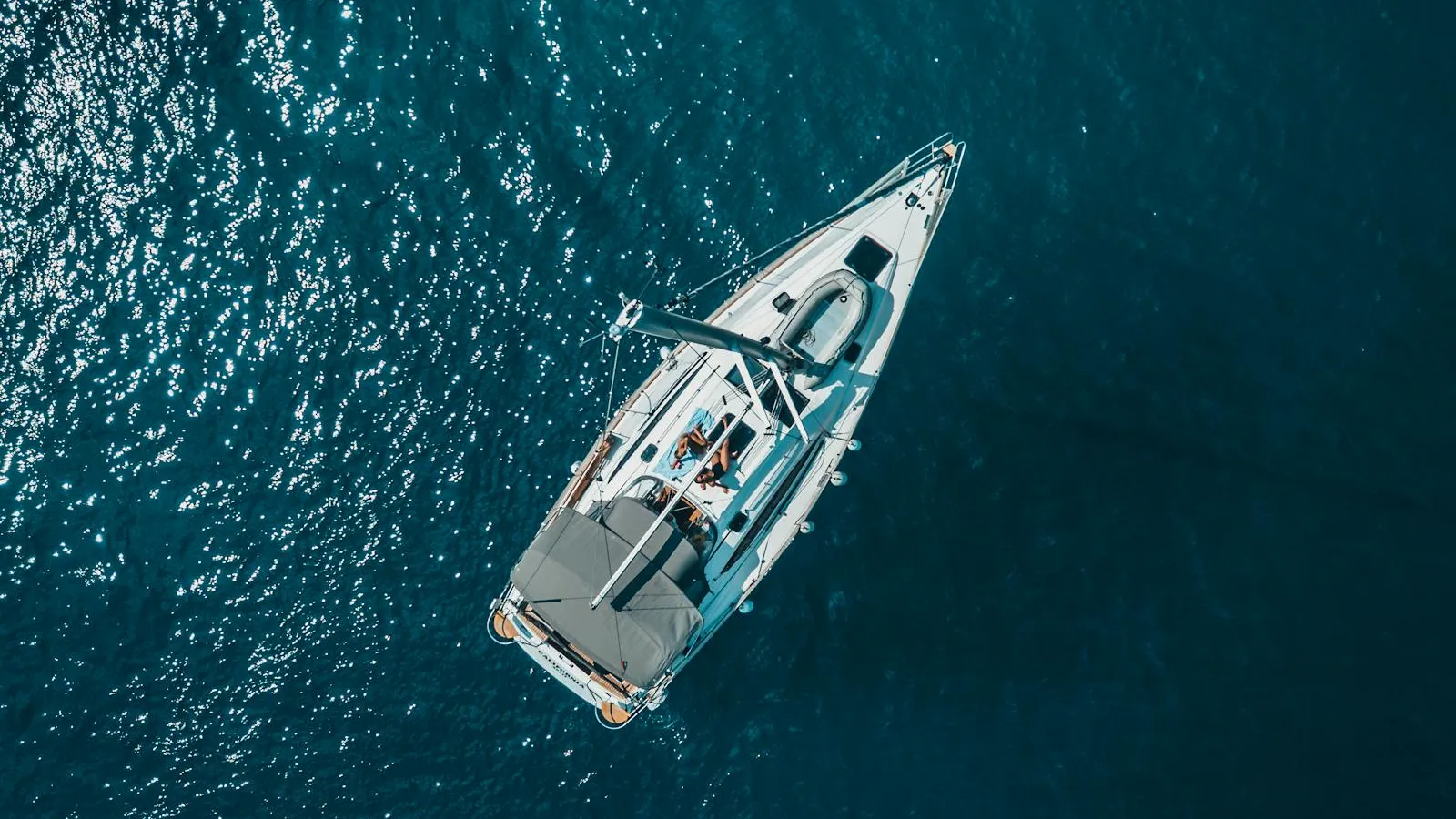 Aerial view of a sailboat on deep blue water